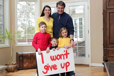 | Fill-A-Need Foundation Katie Cancro and her family with a sign reading: "I won't give up"